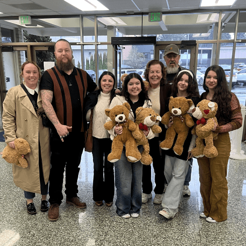 A family holding weighted remembrance bears