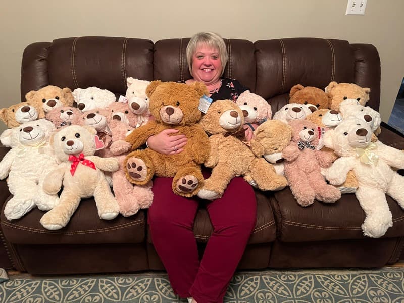 A volunteer holding a weighted remembrance bear