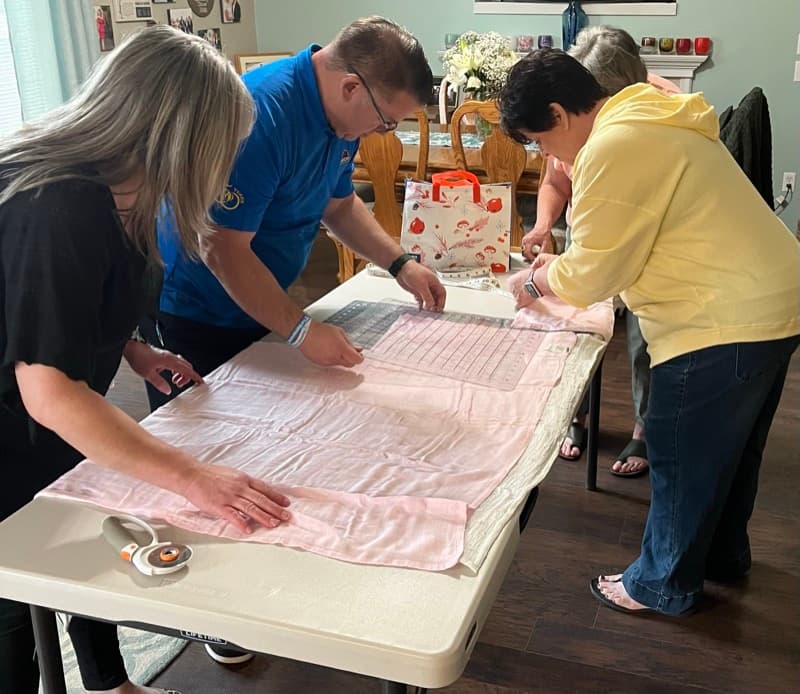 Volunteers preparing blankets for families